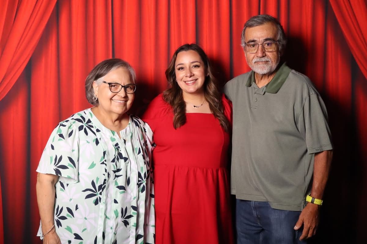 Family portrait at the JVR photo booth with red curtain backdrop