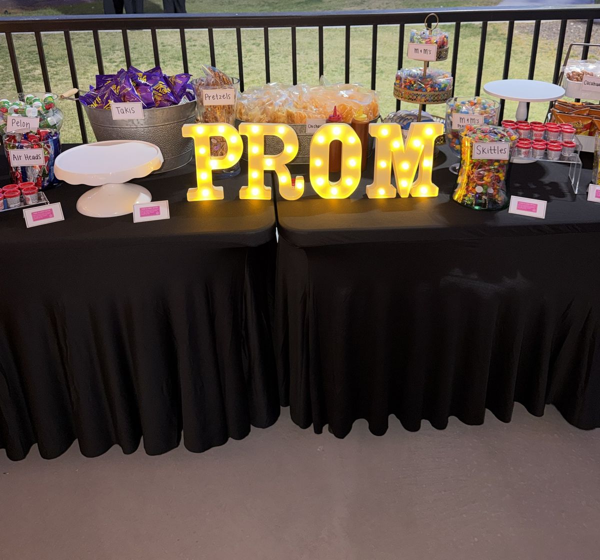 Prom snack table with black spandex table linens and marquee PROM letters