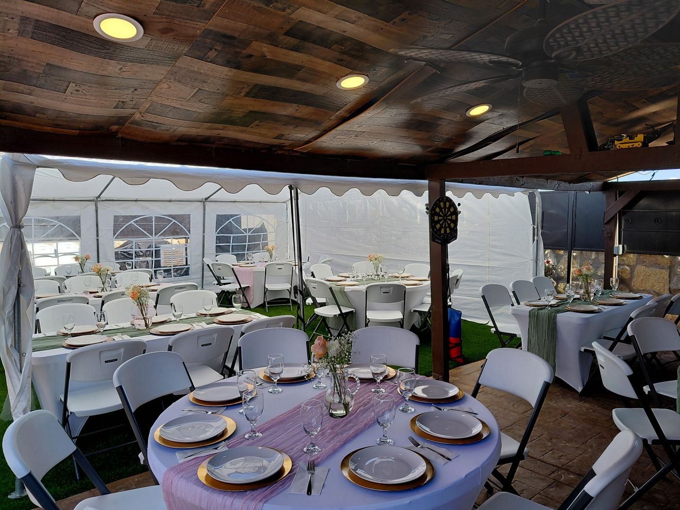 Tent and covered patio reception with round tables in El Paso