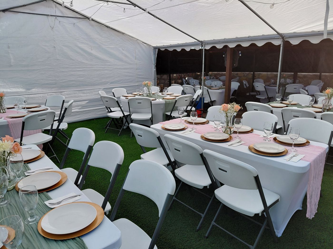 Tables and chairs set up inside an event tent in El Paso