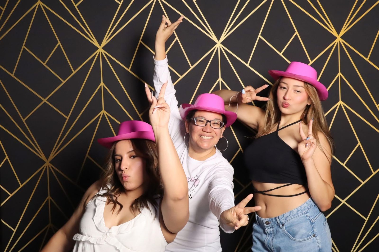 Friends in pink hats at the JVR mirror photo booth in El Paso